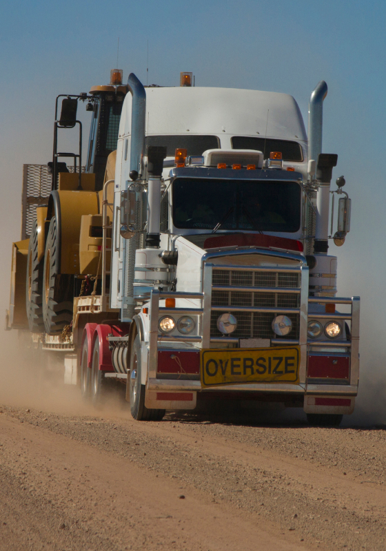 truck carrying tractor